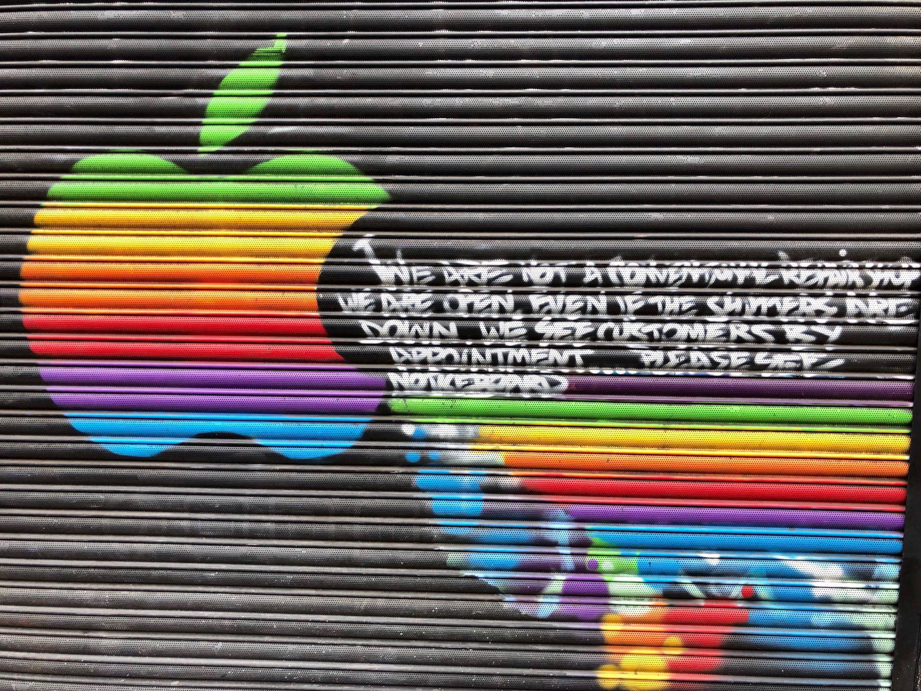 Rainbow Apple logo on the shutters of a shop in Islington, London