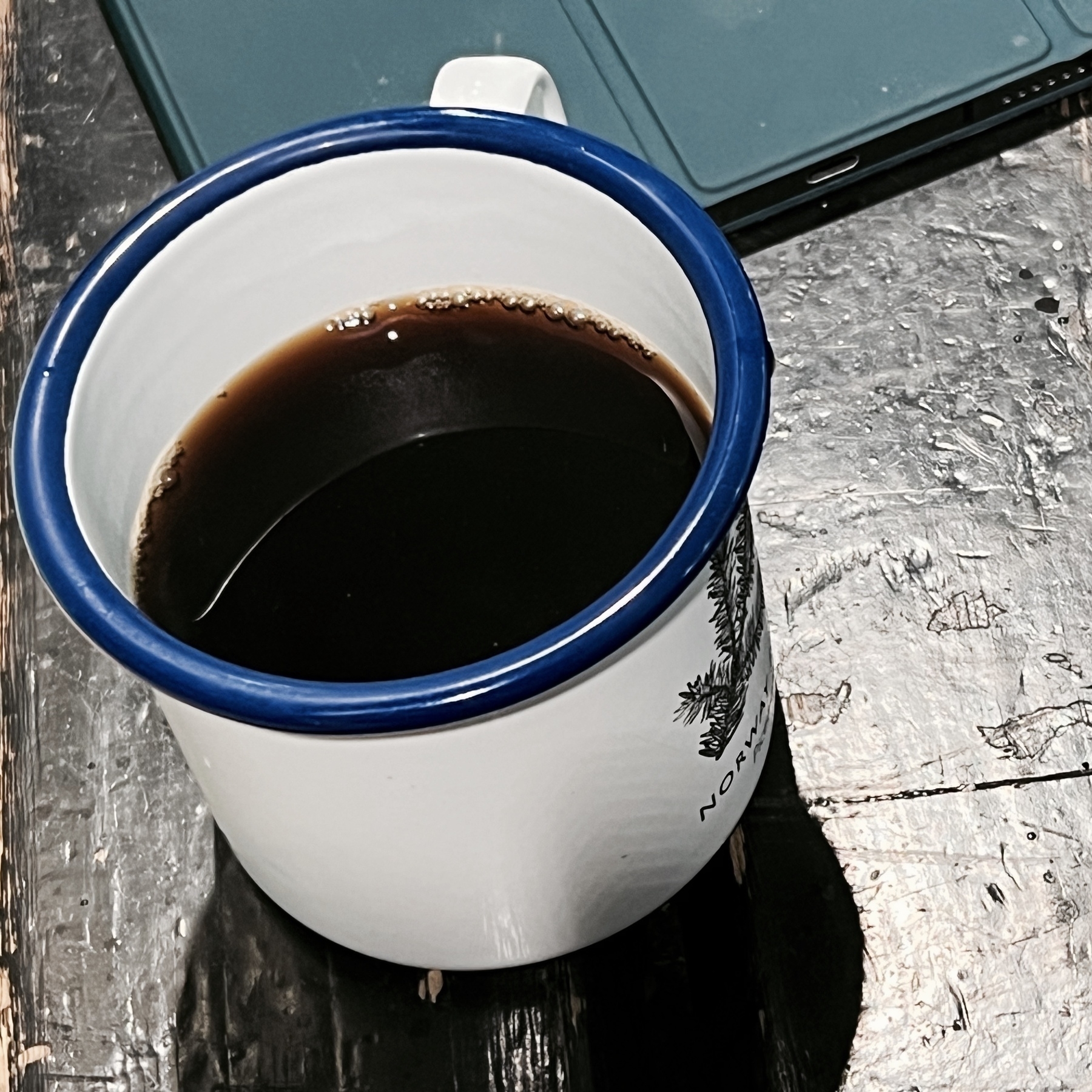 Black coffee in an Ernest Journal enamel mug.
