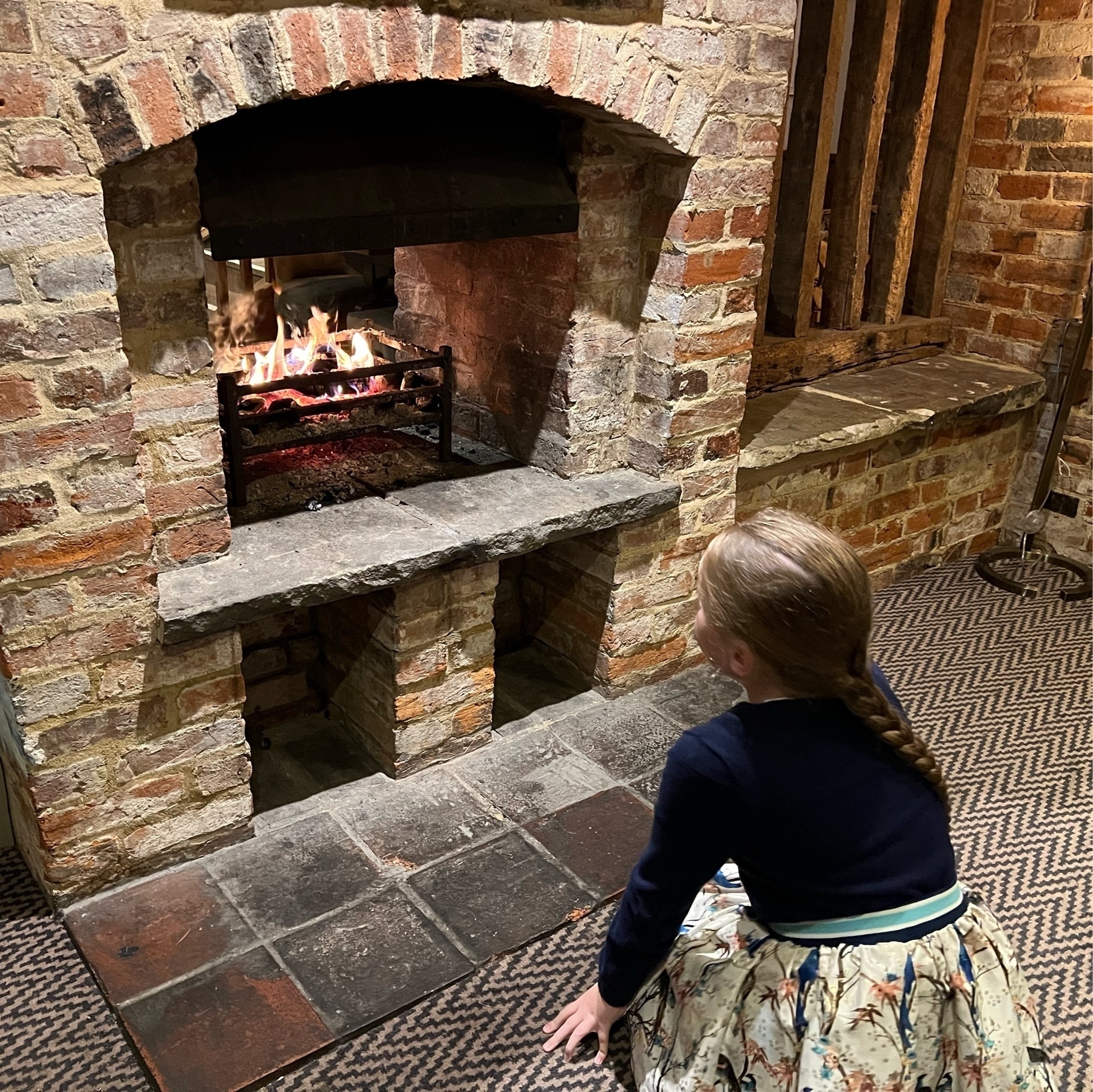 My daughter enjoying an open fire in a pub. 