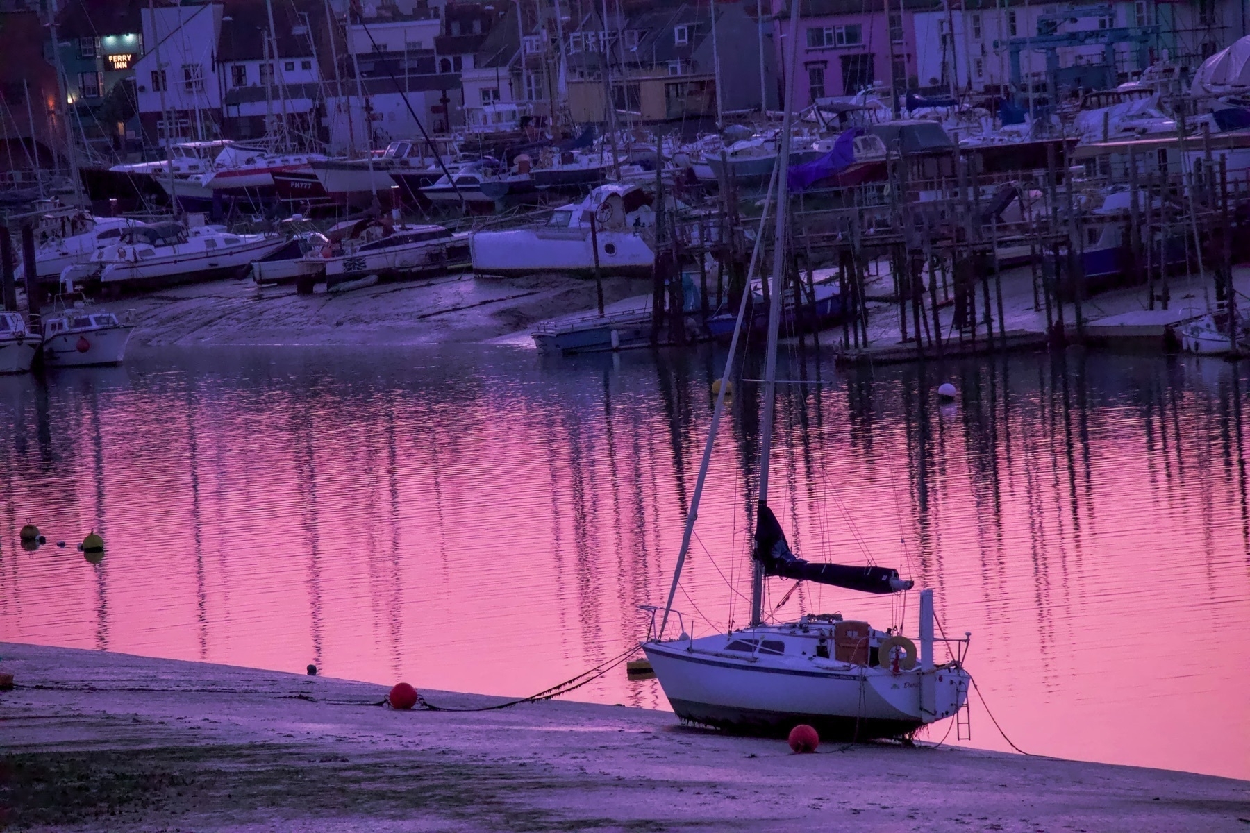 Sunset on the Adur in Shoreham-by-Sea, highlighting boats on the river. 